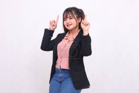 Photo for Beautiful happy Asian office woman in her 20s thin smile wearing suit shirt working professional both hands pointing up high on white color background studio portrait for banner ad, banner, billboard - Royalty Free Image