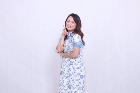 Photo for Beautiful smile asian woman wearing modern chinese dress arms crossed 1 isolated on white background. happy Chinese New Year - Royalty Free Image