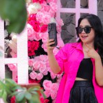 beauty asian girl in pink shirt glasses candid happy hand pointing business cellphone for fashion, lifestyle, banner, promo content