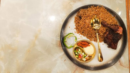 flat lay portrait of nasi kebuli, a typical Arabic food made in Indonesia on a table with empty space beside it