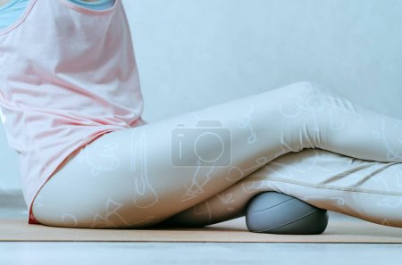 Photo for Hamstrings myofascial release gentle massage with soft grey ball - Royalty Free Image