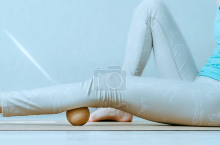 Photo for Person doing calf muscle myofascial release and hydration with cork ball. Concept: self care practices at home, foot pain relief - Royalty Free Image