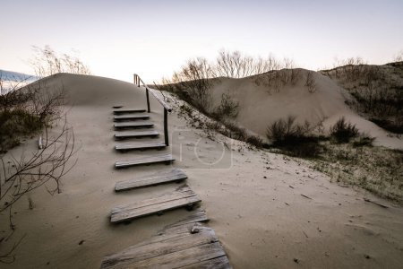 Photo for Parnidis sand dune in sunset. Sandy stairs to th Curonian spit, Nida city, Lithuania. - Royalty Free Image
