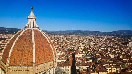 Photo for Firenze, Italy - April 7, 2018: aerial view of Florence cityscape and skyline with Brunelleschis Dome on the left under bright blue clear sky - Royalty Free Image