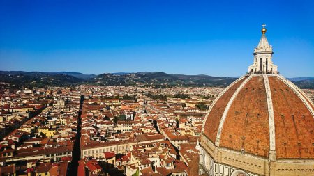Photo for Firenze, Italy - April 7, 2018: aerial view of Florence cityscape and skyline with Brunelleschis Dome on the right under bright blue sky - Royalty Free Image