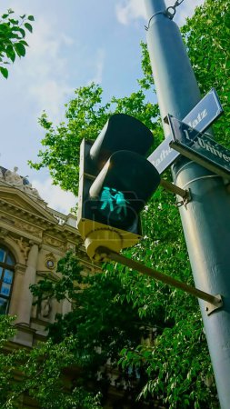 Photo for Vienna, Austria - June 8, 2018: traffic light with two girls on it under a bright blue sky - Royalty Free Image