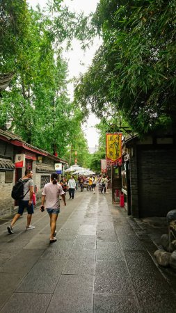 Photo for Chengdu, China - Jun 30, 2018: Tourists without masks walking on Jinli Street in Wuhou Temple with shops on the side before the pandemic on a summer sunny day - Royalty Free Image