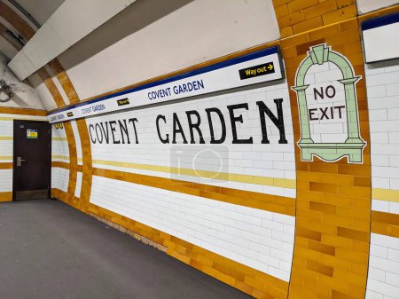 Photo for London, UK - 11.05.2021: Tiled signages of the station name and no exit on Covent Garden Tube Station Piccadilly Line platform with the modern station name and way out signs - Royalty Free Image