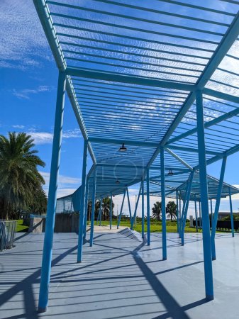 Photo for Hualien, Taiwan - 11.27.2022: Blue metal structure on a public walk path in a park with no people near Dongdamen Night Market with lawn on the side on a sunny day under a blue sky during the pandemic - Royalty Free Image