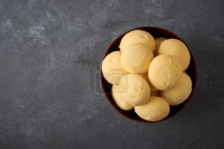 Photo for Ghee biscuits or cookies in a bowl, close-up view of homemade melt in mouth nei biscuits, eggless cookies are made whole wheat flour on a textured dark background with copy space - Royalty Free Image
