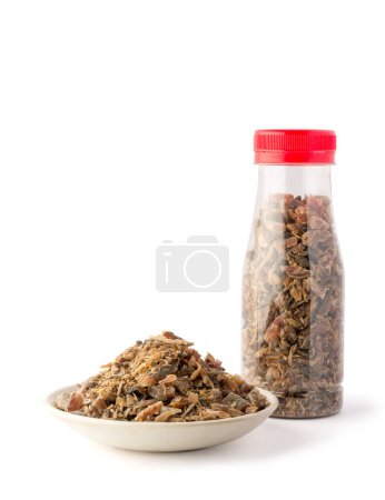 Photo for Maldive fish chips, in a plate and a plastic bottle, dried and cured fish pieces, strong flavor, aromatic ingredient on white background - Royalty Free Image
