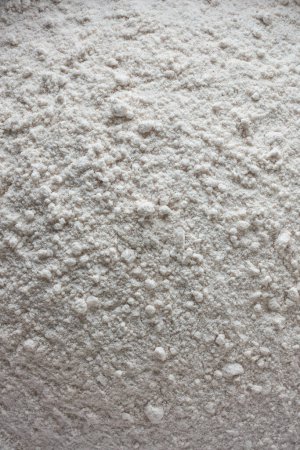 Photo for Pile of rice flour, form of flour made from finely milled rice grains, natural gluten-free common substitute for wheat flour, full frame food background, taken straight from above - Royalty Free Image