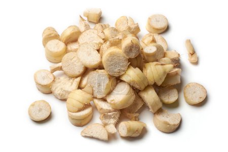 pile of dried organic arrowroot rhizomes pieces to process into powder, maranta arundinacea, tropical plant known for starchy rhizomes harvested various culinary purposes, isolated on white background