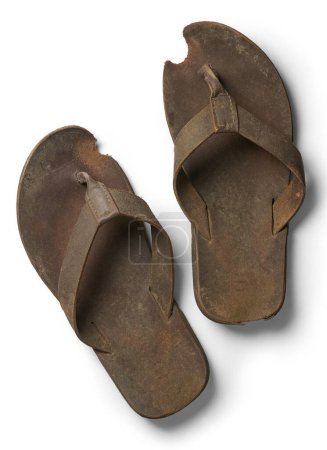 pair of old used sandals slippers isolated white background, dirty significantly worn-out from prolonged use and faded straps taken straight from above