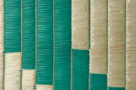plastic woven straw reed mat surface background, abstract of handmade plaited reeds textured wallpaper or backdrop of beach picnic floor covering or decorative purpose
