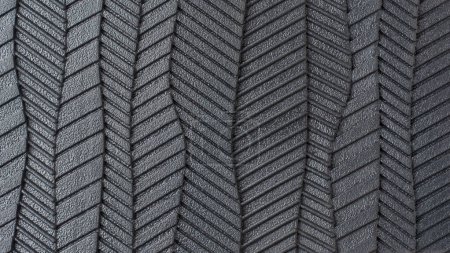Nahaufnahme der Schuhsohle, Abstrakt aus schwarzem Gummi strukturiert und Rillen Oberfläche des Fußbodens in Vollformat, Makrohintergrund oder Tapete für die Gestaltung