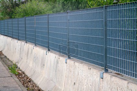 borders, the fence with steel metal grate. Detail of the grate is made with a resistant and solid structure which increases the safety of the premises. rigid electro-welded stainless steel mesh