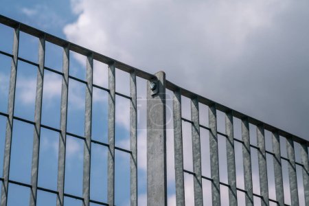 borders, the fence with steel metal grate. Detail of the grate is made with a resistant and solid structure which increases the safety of the premises. rigid electro-welded stainless steel mesh