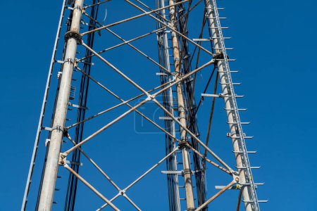 Détails en pylône d'acier, structure réticulaire d'une antenne de répéteur pour les bandes radio, téléphoniques et de communication. Cravates et écrous en acier inoxydable.