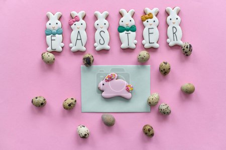 Photo for A chocolate bunny cookies with the quail eggs on a pink background - Royalty Free Image