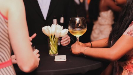 bride and groom holding a bouquet of champagne and a glass of wine