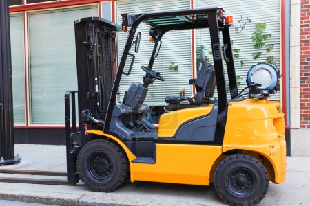 Photo for Forklift truck with a large trailer in the background - Royalty Free Image