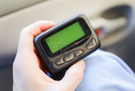Pager is a small wireless device that receives and displays numeric or text messages, symbolizing the era of technological advancements in communication and transition from analog to digital device