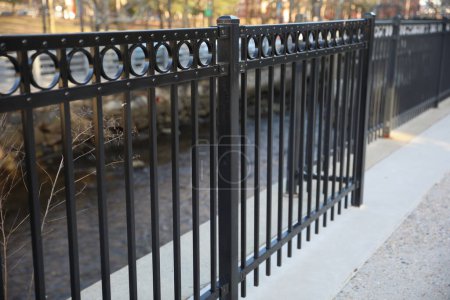 Photo for Metal fence symbolizes protection, security, and confinement. It can represent physical barriers, safety, privacy, or inequality. - Royalty Free Image
