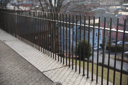 Photo for Metal fence symbolizes protection, security, and confinement. It can represent physical barriers, safety, privacy, or inequality. - Royalty Free Image