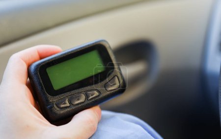 Pager is a small wireless device that receives and displays numeric or text messages, symbolizing the era of technological advancements in communication and transition from analog to digital device