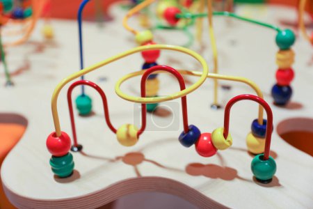 Foto de Juguete clásico laberinto de perlas con cuentas de colores en los cables, que los niños pueden moverse. Simboliza el desarrollo de habilidades motoras en la primera infancia y la coordinación mano-ojo, así como el concepto de causa y efecto - Imagen libre de derechos
