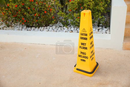 Photo for A yellow wet floor sign is a symbol of caution and warning, indicating a slippery and potentially hazardous area. It represents safety, prevention, and the need for attention and alertness in public - Royalty Free Image