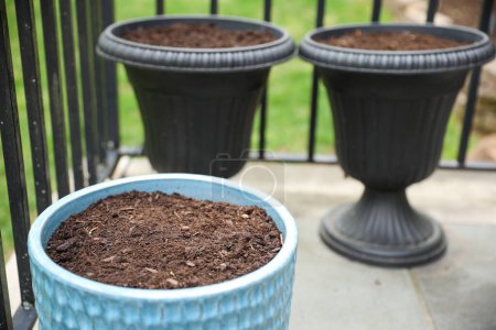 Photo for A flower pot with dirt symbolizes growth, potential, and nurturing. It represents the beginning stages of a plant's life and the care needed for it to thrive - Royalty Free Image