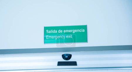 Photo for Exit sign in red and white color signifies a way out or emergency exit. It is an essential safety feature in public and commercial buildings, providing clear and visible guidance to people - Royalty Free Image