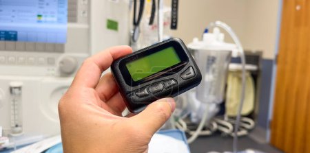 Photo for Hospital work pager and technology symbolize efficient communication and coordination between medical professionals, ensuring timely and effective patient care - Royalty Free Image