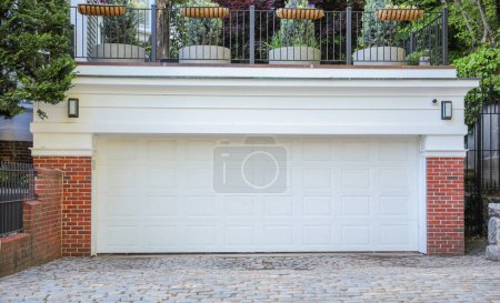 Photo for American home garage and driveway symbolize convenience, transportation, and personal space. They represent the ownership of vehicles, storage, and the entrance to one's private domain - Royalty Free Image