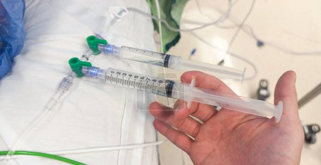 Photo for Hands holding syringe and hospital drugs symbolize medical care, precision, treatment, and the critical role of anesthesia in healthcare - Royalty Free Image
