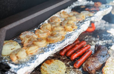 Photo for Barbecue grill with meat, shrimp, chicken, vegetables, and hand grilling food symbolizes festive outdoor cooking and celebration during a national holiday - Royalty Free Image