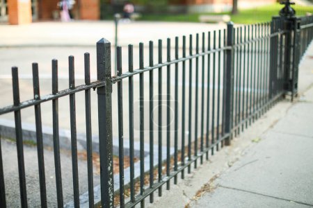 Photo for Metal fence symbolizes boundaries, security, protection, privacy, and delineates spaces with its strong and sturdy presence - Royalty Free Image