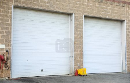 A closed garage door, symbolizing privacy, security, and a barrier between the outside world and personal space