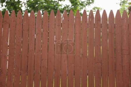 Photo for Weathered wooden fence on the streets symbolizes boundaries, protection, and the passage of time, evoking a sense of security and nostalgia - Royalty Free Image