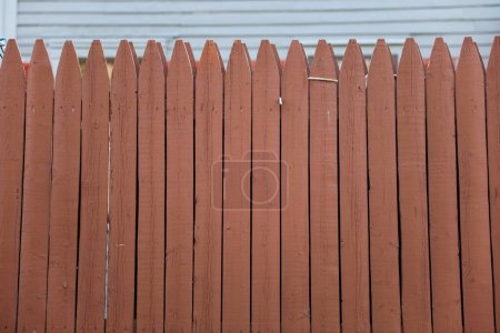 Photo for Weathered wooden fence on the streets symbolizes boundaries, protection, and the passage of time, evoking a sense of security and nostalgia - Royalty Free Image
