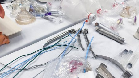 Photo for Hospital airway kit signifies emergency airway management. Endotracheal tube, supraglottic airway, laryngoscope, and Ambu bag symbolize crucial interventions for respiratory support - Royalty Free Image
