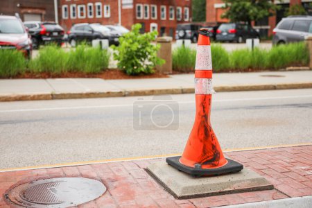 Photo for Bright orange construction cones arranged in a line, symbolizing safety, caution, and ongoing progress in construction and infrastructure projects. The cones represent temporary barriers - Royalty Free Image