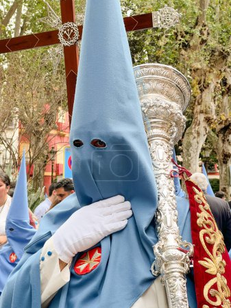 Photo for Brotherhood of Seville Holy Week in Spain . High quality photo, Nazarene holding cross in Holy Week - Royalty Free Image