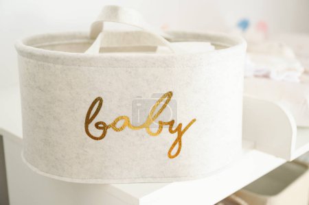 Photo for Textile basket for a newborn baby on a nursery room - Royalty Free Image