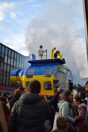 Photo for Liverpool, Merseyside, United Kingdom - May 5 2023: Eurovision Song Contest 2023, the Blue and Yellow Submarine Parade kicks off the party in Liverpool for the launch of EuroVillage fan hub. Man dancing on big parade float. - Royalty Free Image