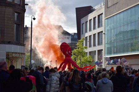 Photo for Liverpool, Merseyside, United Kingdom - May 5 2023: Eurovision Song Contest 2023, the Blue and Yellow Submarine Parade kicks off the party in Liverpool for the launch of EuroVillage fan hub. Giant pink octopus parade float. - Royalty Free Image