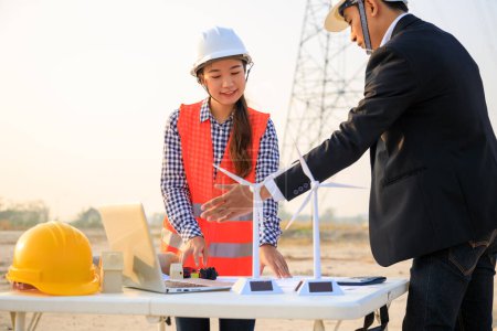 Photo for Construction engineers reviewing blueprints on site - Royalty Free Image