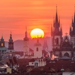A rising sun above the Prague cityscape in spring.